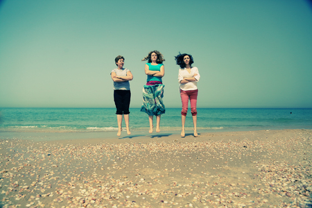 Portrait of three 40 years old women on seasideの写真素材