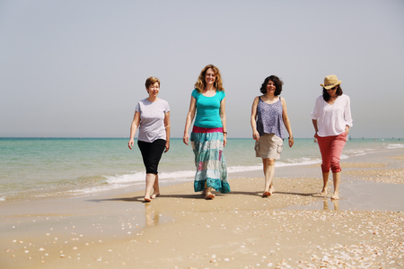 Portrait of four  40 years old women on seasideの写真素材