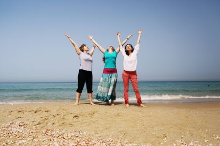Portrait of three 40 years old women on seasideの写真素材
