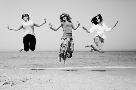Portrait of three 40 years old women on seasideの写真素材