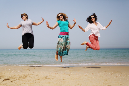 Portrait of three 40 years old women on seasideの写真素材