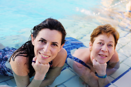 Portrait of two 40 years old women in swimming-poolの写真素材