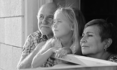 grandfather and grandmother holding 6 years old granddaughterの写真素材