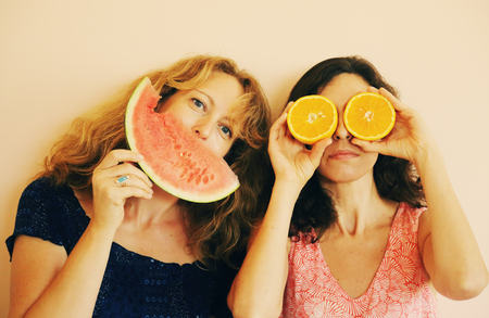 Portrait of 40 years old woman holding orangesの写真素材