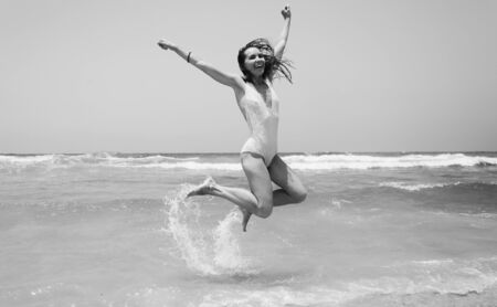 Portrait of happy  real beautiful young woman on seasideの写真素材