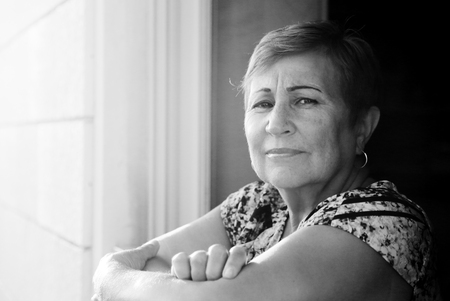 Portrait of senior woman looking from the balconyの写真素材