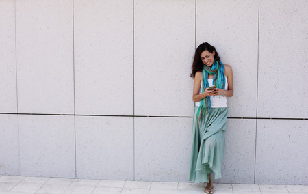 Beautiful woman is holding mobile phoneの写真素材