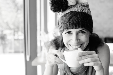 Portrait of beautiful 40 years old woman sitting in the cafeの写真素材