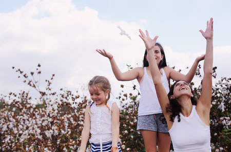 Portrait of beautiful mother with two daughters outdoorsの写真素材