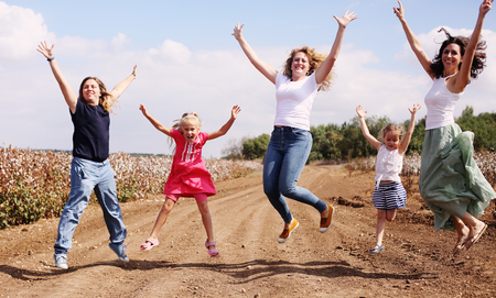 Portrait of beautiful mothers with kids outdoorsの写真素材