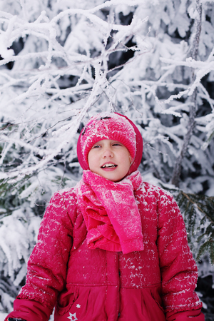 Winter portrait of a adorable 7 years old girl outdoorsの写真素材