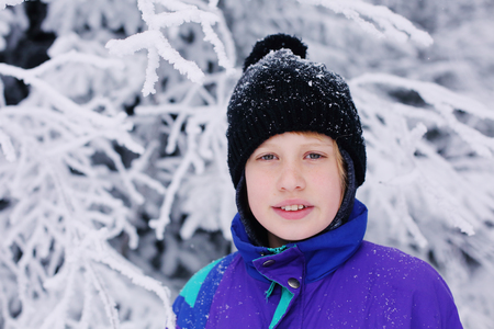 Winter portrait of a adorable autistic boy outdoorsの写真素材