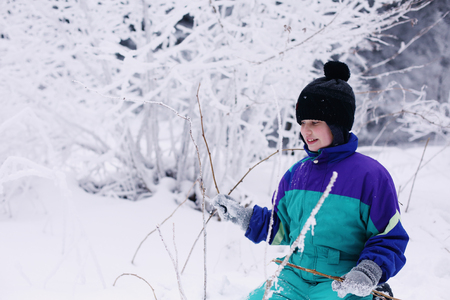 Winter portrait of a adorable autistic boy outdoorsの写真素材