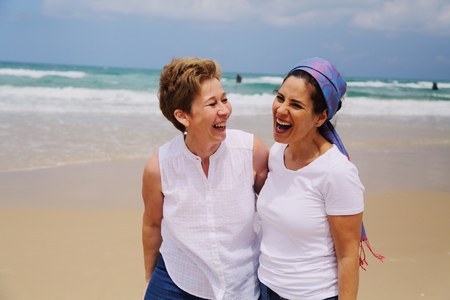 Outdoor portrait of two women standing on the beachの写真素材