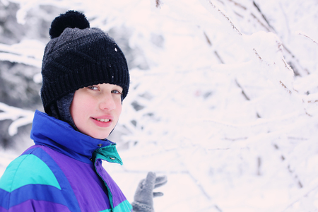 Winter portrait of a adorable autistic boy outdoorsの写真素材