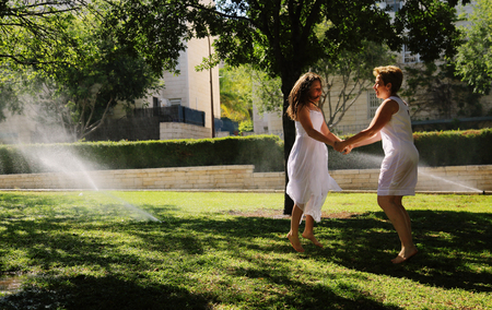 Mother and her daughter having fun in the park. Positive human emotions, feelings, joy.の写真素材