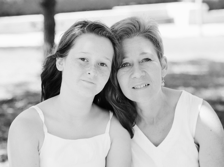 Close up outdoor portrait of mother and daughter. Positive human emotions, feelings, joy.の写真素材