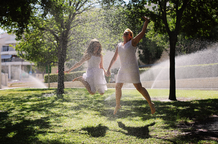Mother and her daughter having fun in the park. Positive human emotions, feelings, joy.の写真素材
