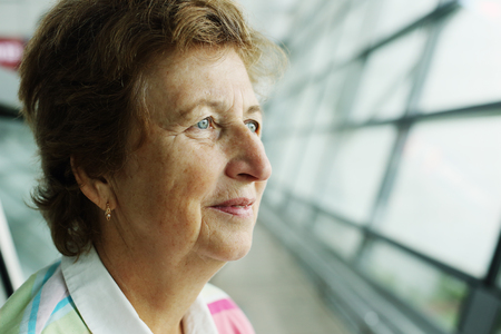 close up indoor portrait of 70 years old senior womanの写真素材
