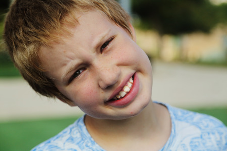 Close up portrait of emotion cute autistic boyの写真素材