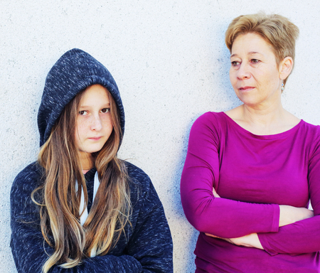 Portrait of mother with teenager daughter. Teenage problems.の写真素材