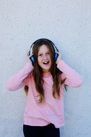 Portrait of cute teenage girl listening music on headphonesの写真素材