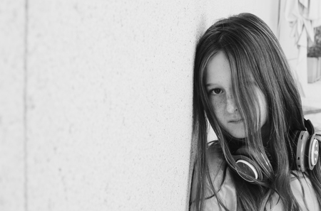 Portrait of cute teenage girl listening music on headphonesの写真素材