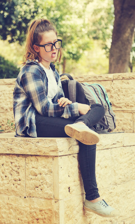 Portrait of tenage girl sitting outdoorの写真素材