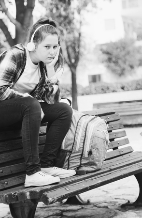 Portrait of tenage girl sitting outdoorの写真素材