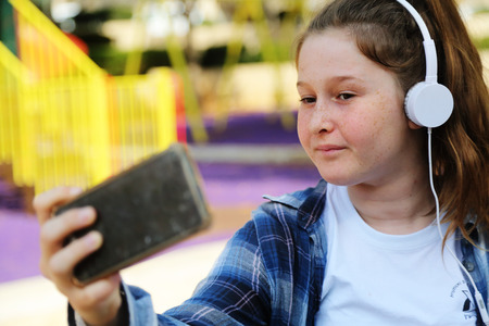 Portrait of tenage girl sitting outdoorの写真素材