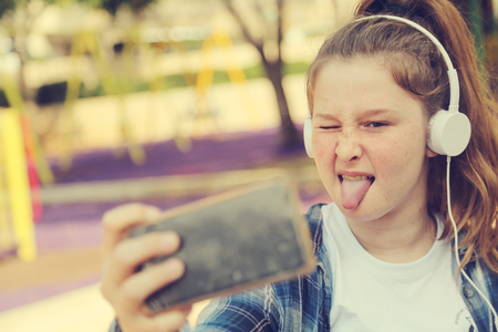 Portrait of teenage girl sitting outdoorの写真素材