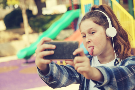 Portrait of teenage girl sitting outdoorの写真素材