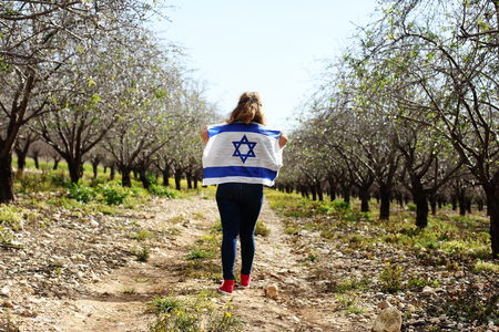Woman holding an Israeli flagの写真素材
