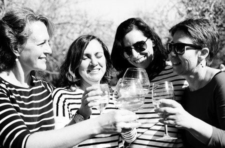 smiling real mature women is holding champagne glassesの写真素材