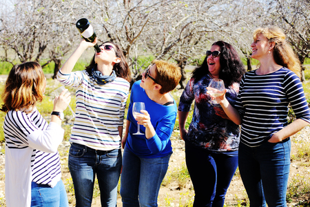 smiling real mature women is holding champagne glassesの写真素材