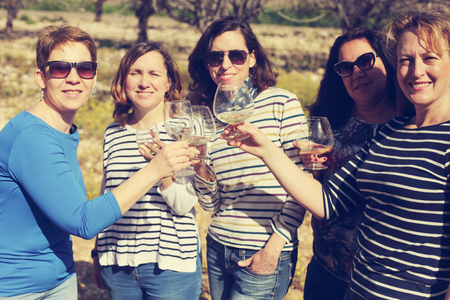 smiling real mature women is holding champagne glassesの写真素材