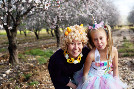 Outdoor portrait of mother and daughter in carnival costumeの写真素材