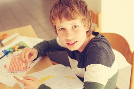 Cute 12 years old autistic boy drawingの写真素材