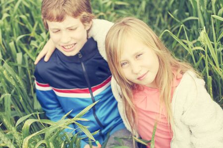 Portrait of sister  with her autistic brother enjoying  freedom and summer. Ending coronavirus quarantine, out of covid-19 quarantine.の写真素材