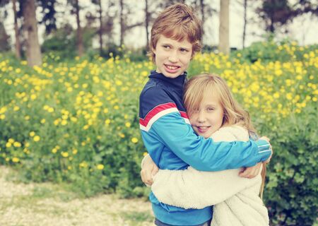 Portrait of sister  with her autistic brother enjoying  freedom and summer. Ending coronavirus quarantine, out of covid-19 quarantine.の写真素材