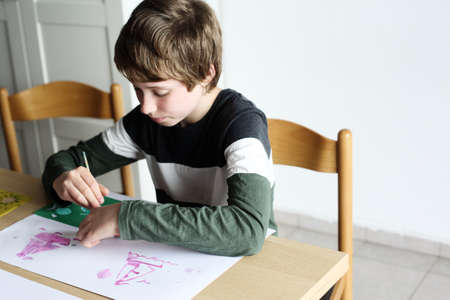 Cute 12 years old autistic boy drawingの写真素材