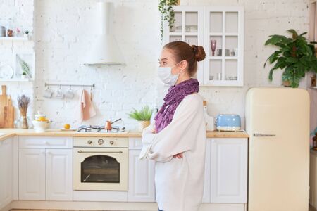 Girl in medical mask on white background empty spaceの写真素材