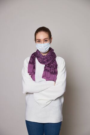 Girl in medical mask on white background empty spaceの写真素材