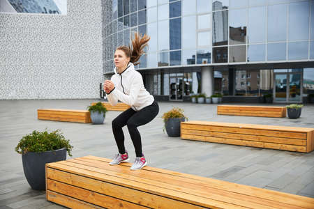 Fitness woman jumping outdoor in urban environmentの写真素材