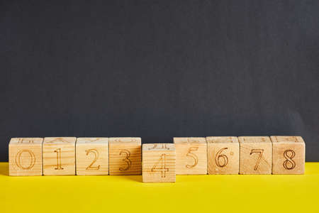 Numbers on wooden cubes in line . The number four is in forward.の写真素材