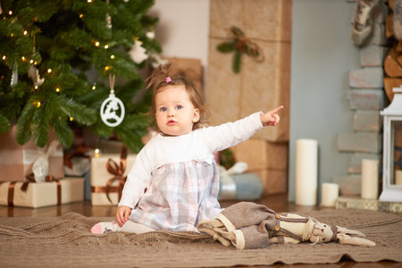 Little cute girl with gifts and box with christmas decorの写真素材