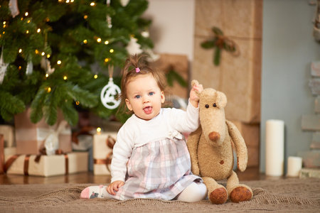 Little cute girl with gifts and box with christmas decorの写真素材