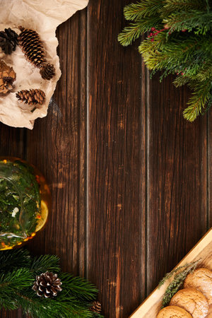 Wooden background, craft paper, cookies, herbal tea and spruce branches, holiday compositionの写真素材