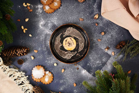 Christmas, new year. Blue background, nuts, powdered sugar, ceramic utensils in the center.の写真素材
