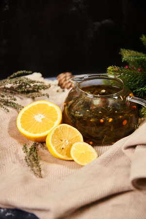 Glass teapot with lemons, Christmas decor with spruceの写真素材